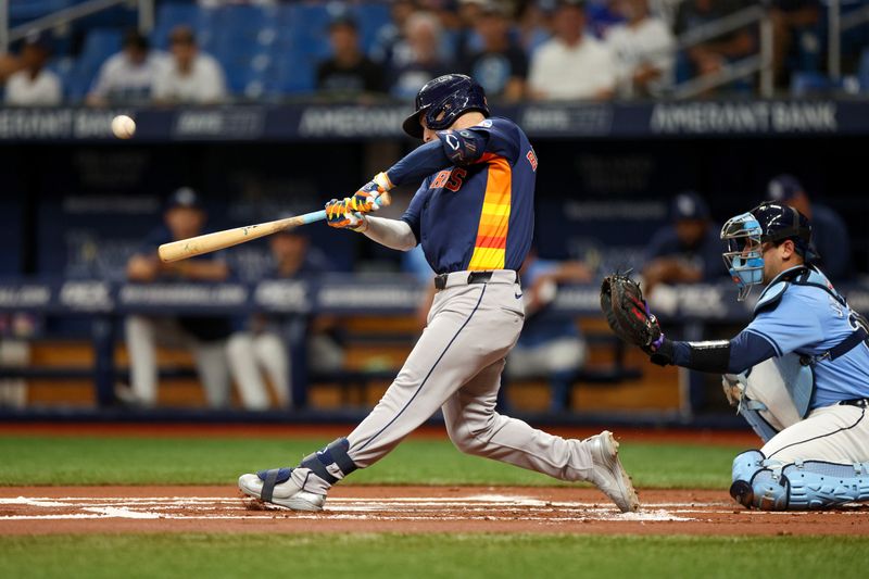 Aug 12, 2024; St. Petersburg, Florida, USA; Houston Astros third baseman Alex Bregman (2) hits a home run against the Tampa Bay Rays in the first inning  at Tropicana Field. Mandatory Credit: Nathan Ray Seebeck-USA TODAY Sports