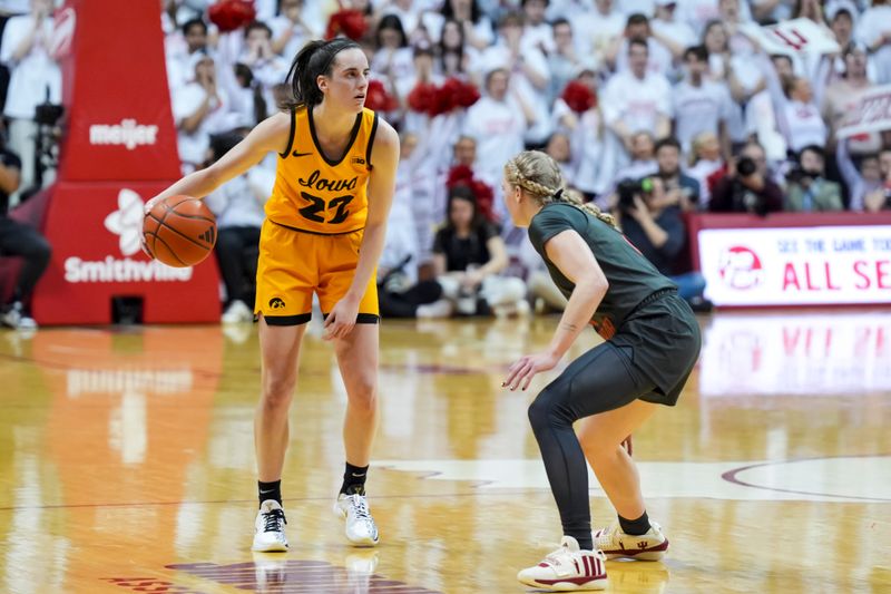 Feb 22, 2024; Bloomington, Indiana, USA;  Iowa Hawkeyes guard Caitlin Clark (22) dribbles the ball against Indiana Hoosiers guard Lexus Bargesser (1) in the first half at Simon Skjodt Assembly Hall. Mandatory Credit: Aaron Doster-USA TODAY Sports