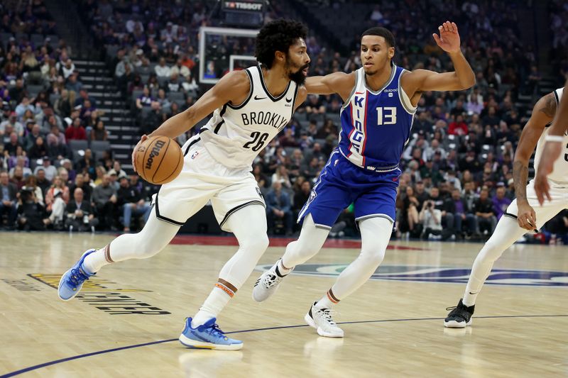 SACRAMENTO, CALIFORNIA - DECEMBER 11: Spencer Dinwiddie #26 of the Brooklyn Nets is guarded by Keegan Murray #13 of the Sacramento Kings in the first half at Golden 1 Center on December 11, 2023 in Sacramento, California. NOTE TO USER: User expressly acknowledges and agrees that, by downloading and or using this photograph, User is consenting to the terms and conditions of the Getty Images License Agreement.  (Photo by Ezra Shaw/Getty Images)