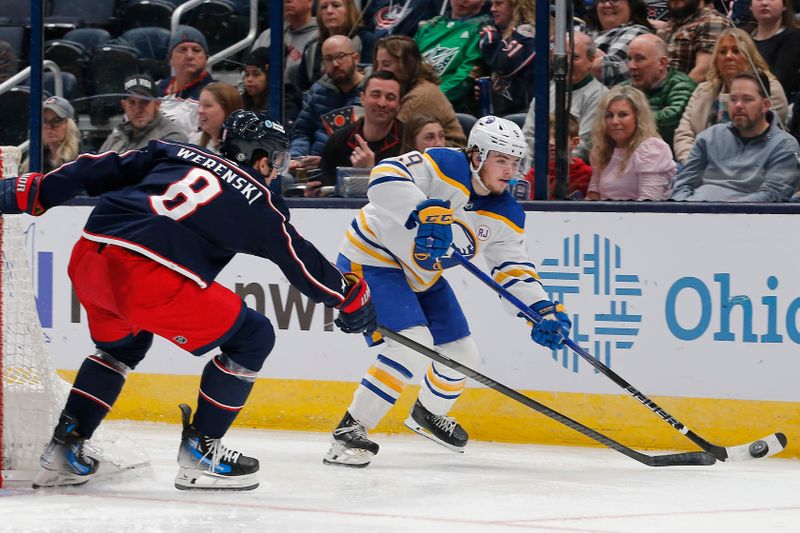 Feb 23, 2024; Columbus, Ohio, USA; Buffalo Sabres left wing Zach Benson (9) carries the puck as Columbus Blue Jackets defenseman Zach Werenski (8) defends during the second period at Nationwide Arena. Mandatory Credit: Russell LaBounty-USA TODAY Sports