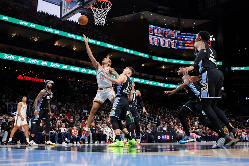 ATLANTA, GEORGIA - JANUARY 15: Jeremy Sochan #10 of the San Antonio Spurs scores over Bogdan Bogdanovic #13 of the Atlanta Hawks during the second half at State Farm Arena on January 15, 2024 in Atlanta, Georgia. NOTE TO USER: User expressly acknowledges and agrees that, by downloading and or using this photograph, User is consenting to the terms and conditions of the Getty Images License Agreement. (Photo by Alex Slitz/Getty Images)