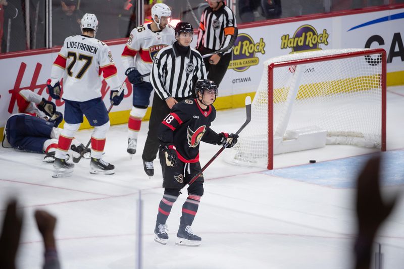 Oct 10, 2024; Ottawa, Ontario, CAN; Ottawa Senators center Tim Stutzle (18) scores an empty net goal after battling with Florida Panthers center Aleksander Barkov (16) who sustained an injury on the play in the third period at the Canadian Tire Centre. Mandatory Credit: Marc DesRosiers-Imagn Images