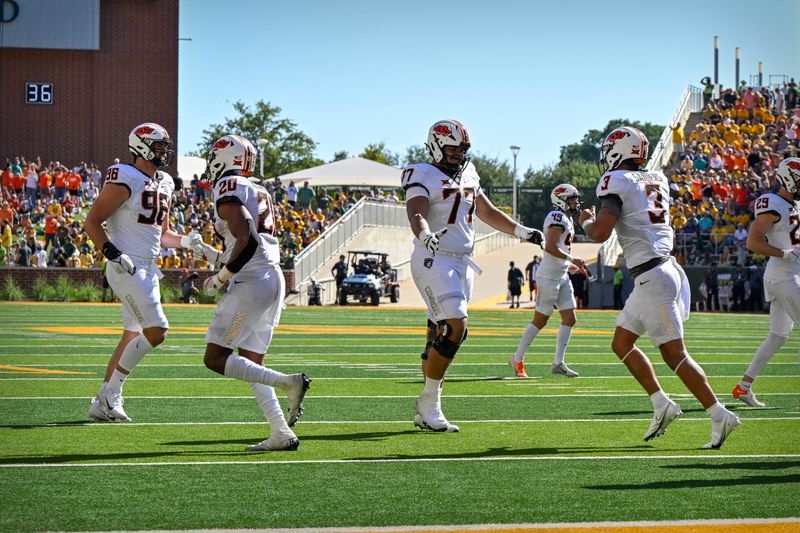 Oct 1, 2022; Waco, Texas, USA; Oklahoma State Cowboys defensive end Kody Walterscheid (96) and running back Dominic Richardson (20) and offensive lineman Tyrone Webber (77) and quarterback Spencer Sanders (3) celebrate after Sanders scores a touchdown against the Baylor Bears during the second quarter at McLane Stadium. Mandatory Credit: Jerome Miron-USA TODAY Sports