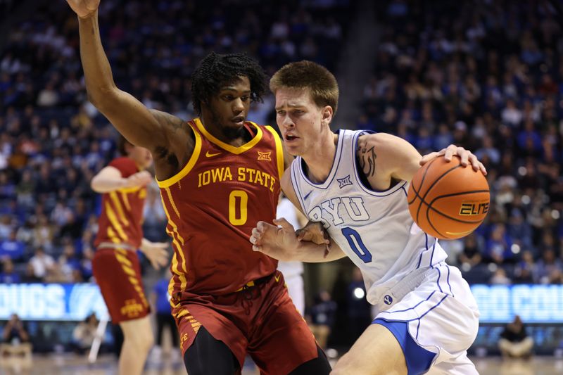 Jan 16, 2024; Provo, Utah, USA; Brigham Young Cougars forward Noah Waterman (0) drives to the basket against Iowa State Cyclones forward Tre King (0) during the first half at Marriott Center. Mandatory Credit: Rob Gray-USA TODAY Sports