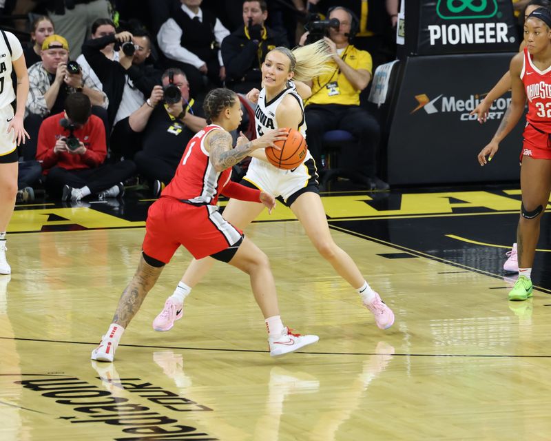 Mar 3, 2024; Iowa City, Iowa, USA; Iowa Hawkeyes guard Kylie Feuerbach (4) defends Ohio State Buckeyes guard Rikki Harris (1) during the first half at Carver-Hawkeye Arena. Mandatory Credit: Reese Strickland-USA TODAY Sports