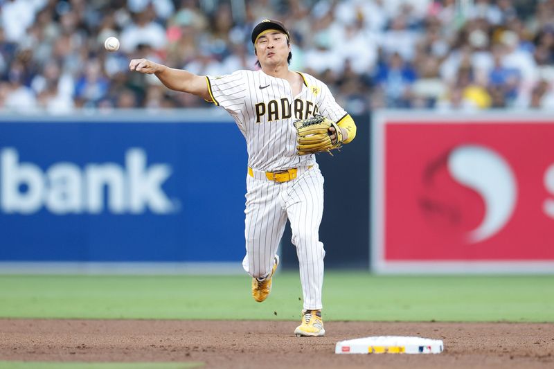 Jul 31, 2024; San Diego, California, USA; San Diego Padres shortstop Ha-Seong Kim (7) throws to first base for an out during the fifth inning against the Los Angeles Dodgers at Petco Park. Mandatory Credit: David Frerker-USA TODAY Sports
