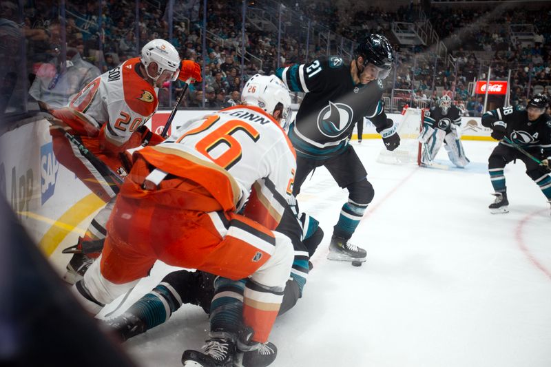 Oct 12, 2024; San Jose, California, USA; Anaheim Ducks right winger Brett Leason (20) and left winger Brock McGinn (26) battle for the puck with San Jose Sharks center Alexander Wennberg (21) during the second period at SAP Center at San Jose. Mandatory Credit: D. Ross Cameron-Imagn Images