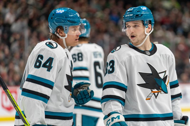 Mar 3, 2024; Saint Paul, Minnesota, USA; San Jose Sharks defenseman Calen Addison (33) and center Mikael Granlund (64) discuss the play before a face-off against the Minnesota Wild in the third period at Xcel Energy Center. Mandatory Credit: Matt Blewett-USA TODAY Sports