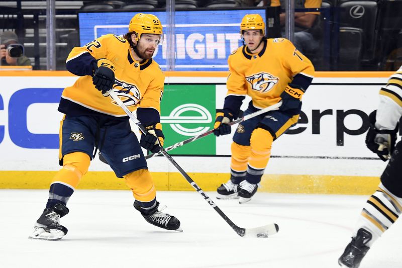 Apr 2, 2024; Nashville, Tennessee, USA; Nashville Predators center Tommy Novak (82) shoots the puck during the first period against the Boston Bruins at Bridgestone Arena. Mandatory Credit: Christopher Hanewinckel-USA TODAY Sports