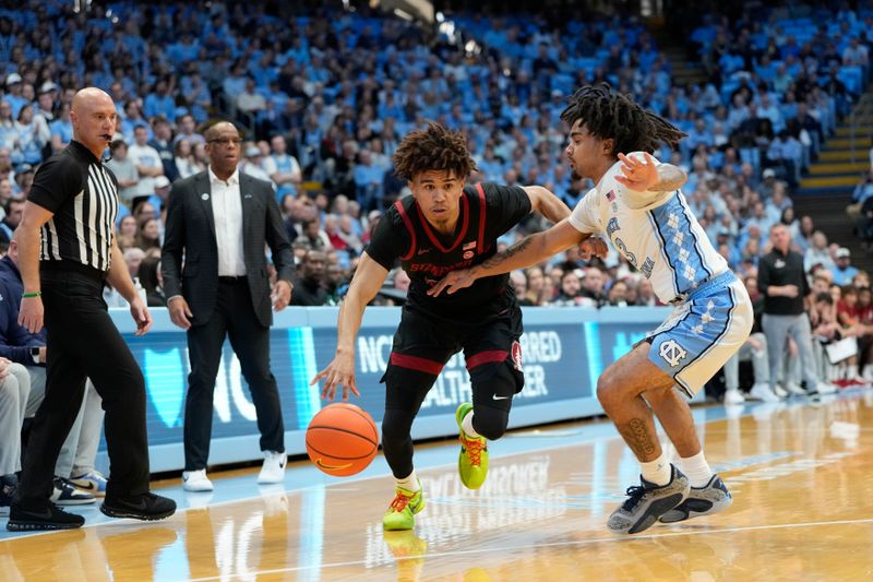 Jan 18, 2025; Chapel Hill, North Carolina, USA; Stanford Cardinal guard Oziyah Sellers (4) dribbles as North Carolina Tar Heels guard Elliot Cadeau (3) defends in the first half at Dean E. Smith Center. Mandatory Credit: Bob Donnan-Imagn Images