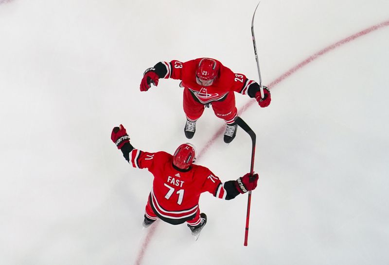 Dec 28, 2023; Raleigh, North Carolina, USA; Carolina Hurricanes right wing Jesper Fast (71) is congratulated by Carolina Hurricanes right wing Stefan Noesen (23) after his goal against the Montreal Canadiens during the second period at PNC Arena. Mandatory Credit: James Guillory-USA TODAY Sports