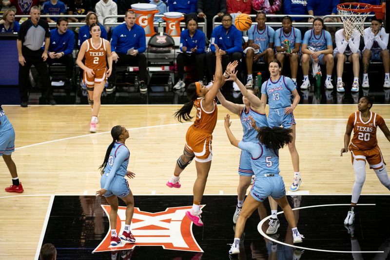 Mar 9, 2024; Kansas City, MO, USA; Texas Longhorns forward Aaliyah Moore (23) shoots the ball while defended by Kansas Jayhawks center Danai Papadopoulou (14) and guard Ryan Cobbins (5) during the first half at T-Mobile Center. Mandatory Credit: Amy Kontras-USA TODAY Sports