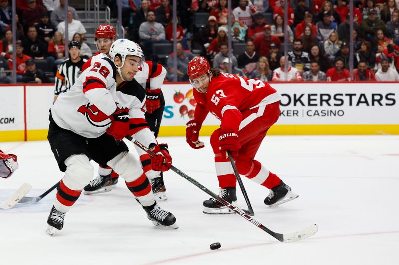 Oct 24, 2024; Detroit, Michigan, USA;  New Jersey Devils right wing Timo Meier (28) skates with the puck defended by Detroit Red Wings defenseman Moritz Seider (53) in the third period at Little Caesars Arena. Mandatory Credit: Rick Osentoski-Imagn Images