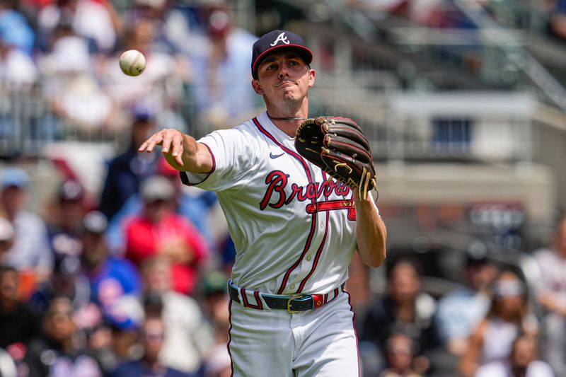 Apr 11, 2024; Cumberland, Georgia, USA; Atlanta Braves starting pitcher Allan Winans (72) throws out New York Mets shortstop Francisco Lindor (12) after fielding a ground ball during the second inning at Truist Park. Mandatory Credit: Dale Zanine-USA TODAY Sports