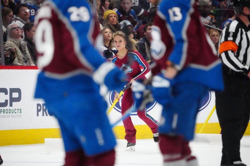 Jan 2, 2024; Denver, Colorado, USA; Colorado Avalanche ice patrol Sydney Browne clears the rink in the first period against the New York Islanders at Ball Arena. Mandatory Credit: Ron Chenoy-USA TODAY Sports