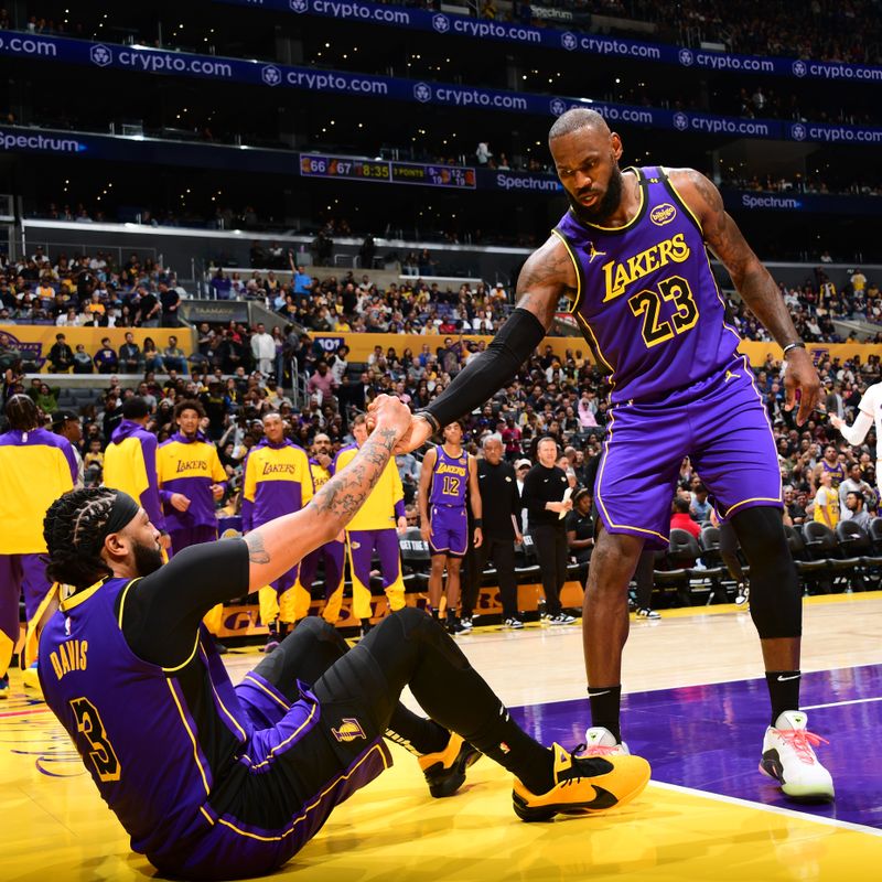 LOS ANGELES, CA - OCTOBER 25: LeBron James #23 j helps up Anthony Davis #3 of the Los Angeles Lakers during the game against the Phoenix Sunson October 25, 2024 at Crypto.Com Arena in Los Angeles, California. NOTE TO USER: User expressly acknowledges and agrees that, by downloading and/or using this Photograph, user is consenting to the terms and conditions of the Getty Images License Agreement. Mandatory Copyright Notice: Copyright 2024 NBAE (Photo by Adam Pantozzi/NBAE via Getty Images)