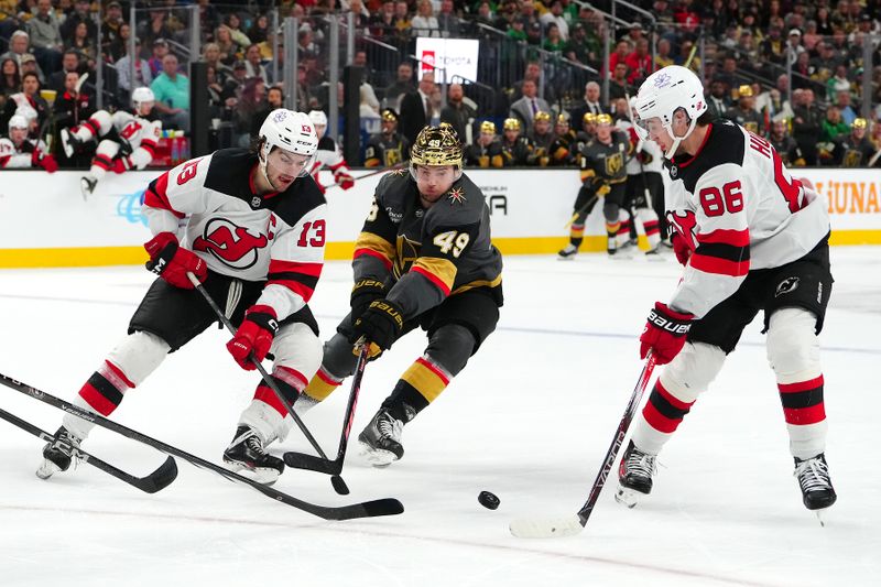 Mar 17, 2024; Las Vegas, Nevada, USA; Vegas Golden Knights center Ivan Barbashev (49) misses a pass from New Jersey Devils center Nico Hischier (13) to New Jersey Devils center Jack Hughes (86) during the second period at T-Mobile Arena. Mandatory Credit: Stephen R. Sylvanie-USA TODAY Sports