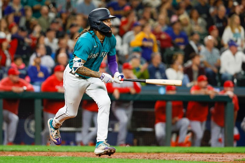 Sep 12, 2023; Seattle, Washington, USA; Seattle Mariners shortstop J.P. Crawford (3) hits a three-run double against the Los Angeles Angels during the fourth inning at T-Mobile Park. Mandatory Credit: Joe Nicholson-USA TODAY Sports