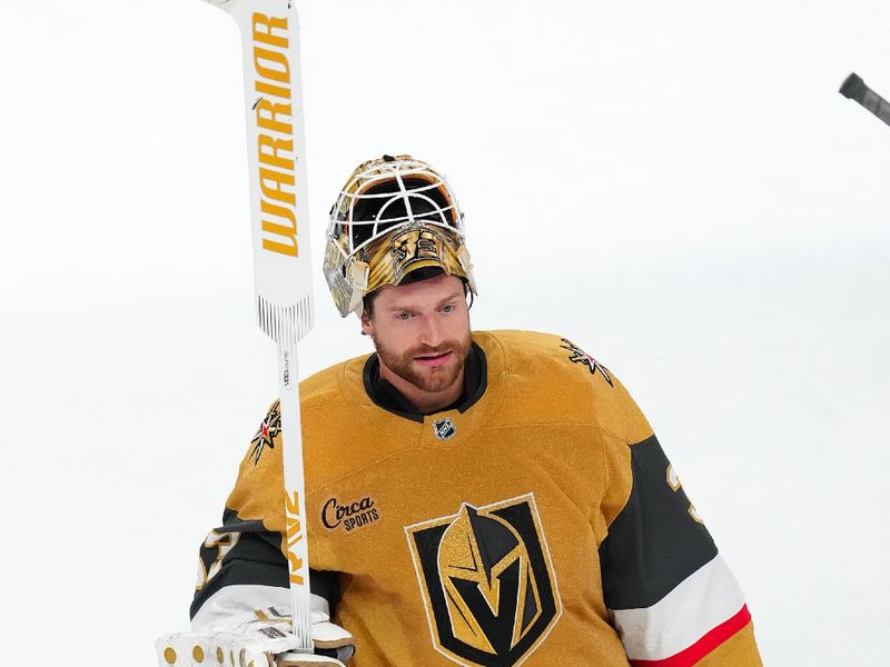 Oct 11, 2024; Las Vegas, Nevada, USA; Vegas Golden Knights goaltender Adin Hill (33) celebrates after the Golden Knights defeated the St. Louis Blues 4-3 at T-Mobile Arena. Mandatory Credit: Stephen R. Sylvanie-Imagn Images