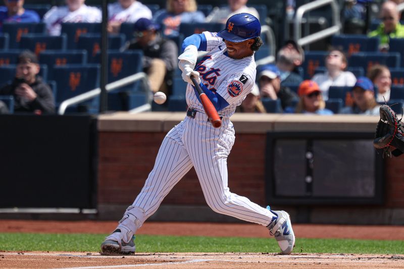 Apr 20, 2025; New York City, New York, USA;  New York Mets shortstop Francisco Lindor (12) hits a solo home run during the first inning against the St. Louis Cardinals at Citi Field. Mandatory Credit: Vincent Carchietta-Imagn Images