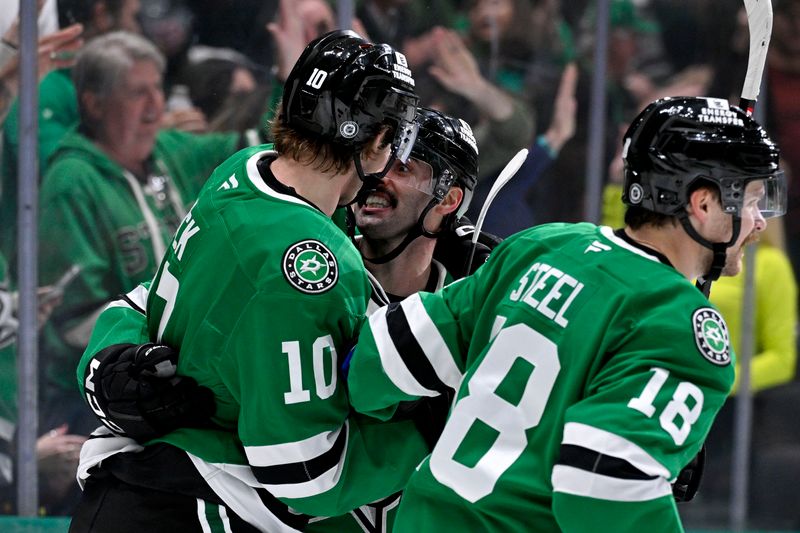 Nov 14, 2024; Dallas, Texas, USA; Dallas Stars center Oskar Back (10) and center Colin Blackwell (15) and center Sam Steel (18) celebrates after Back scores his first career NHL goal during the second period against the Boston Bruins at the American Airlines Center. Mandatory Credit: Jerome Miron-Imagn Images