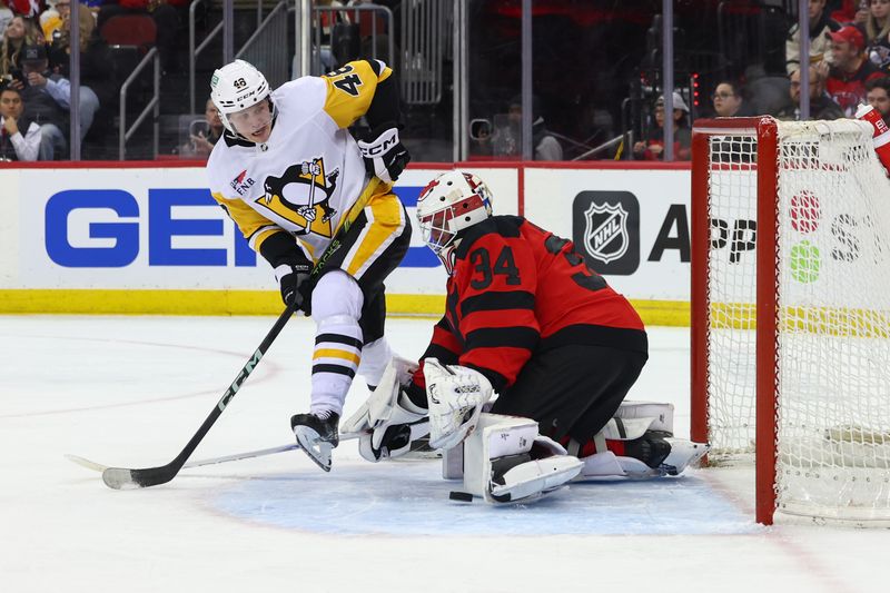 Mar 19, 2024; Newark, New Jersey, USA; New Jersey Devils goaltender Jake Allen (34) makes a save against the Pittsburgh Penguins during the first period at Prudential Center. Mandatory Credit: Ed Mulholland-USA TODAY Sports