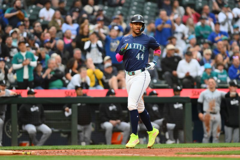 Jun 11, 2024; Seattle, Washington, USA; Seattle Mariners center fielder Julio Rodriguez (44) scores a run against the Chicago White Sox during the third inning at T-Mobile Park. Mandatory Credit: Steven Bisig-USA TODAY Sports