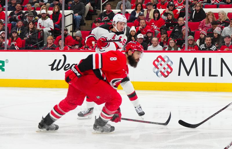 Oct 15, 2024; Raleigh, North Carolina, USA;  New Jersey Devils center Jack Hughes (86) scores a goal against the Carolina Hurricanes during the second period at PNC Arena. Mandatory Credit: James Guillory-Imagn Images