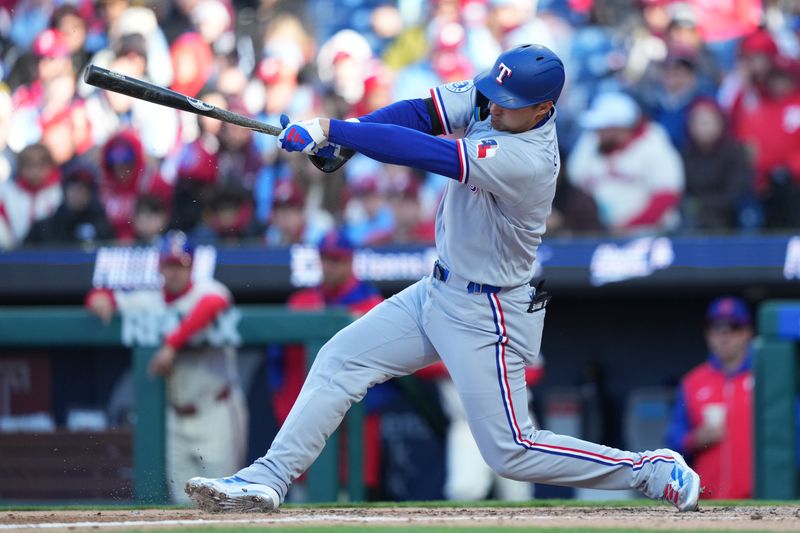 Mar 28, 2026; Philadelphia, Pennsylvania, USA; Texas Rangers infielder Corey Seager (5) hits a single against the Philadelphia Phillies in the fifth inning at Citizens Bank Park. Mandatory Credit: Kyle Ross-Imagn Images