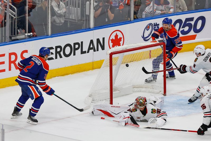 Nov 1, 2025; Edmonton, Alberta, CAN; Edmonton Oilers defensemen Evan Bouchard (2) scores the game winning goal during overtime against the Chicago Blackhawks at Rogers Place. Mandatory Credit: Perry Nelson-Imagn Images