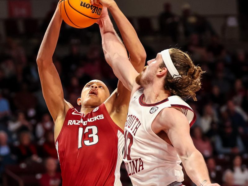 Feb 4, 2023; Columbia, South Carolina, USA; Arkansas Razorbacks guard Jordan Walsh (13) and South Carolina Gamecocks forward Hayden Brown (10) battle for a rebound in the second half at Colonial Life Arena. Mandatory Credit: Jeff Blake-USA TODAY Sports