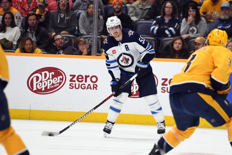 Apr 9, 2024; Nashville, Tennessee, USA; Winnipeg Jets center Mark Scheifele (55) waits to pass the puck during the second period against the Nashville Predators at Bridgestone Arena. Mandatory Credit: Christopher Hanewinckel-USA TODAY Sports