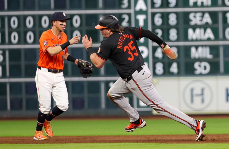 Jun 21, 2024; Houston, Texas, USA; Baltimore Orioles designated hitter Adley Rutschman (35) runs past Houston Astros shortstop Mauricio Dubon (14) to third base in the fifth inning at Minute Maid Park. Mandatory Credit: Thomas Shea-USA TODAY Sports