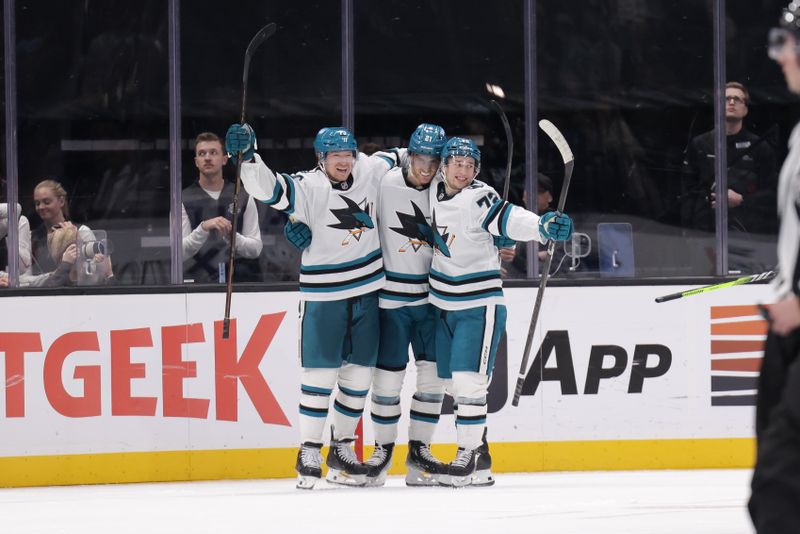 Oct 28, 2024; Salt Lake City, Utah, USA;  San Jose Sharks center Alexander Wennberg (21) celebrates with teammates after scoring the game winning goal during over-time against the Utah Hockey Club at Delta Center. Mandatory Credit: Chris Nicoll-Imagn Images