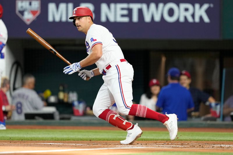 Jun 27, 2023; Arlington, Texas, USA; Texas Rangers first baseman Nathaniel Lowe (30) follows through on his singleagainst the Detroit Tigers during the first inning at Globe Life Field. Mandatory Credit: Jim Cowsert-USA TODAY Sports