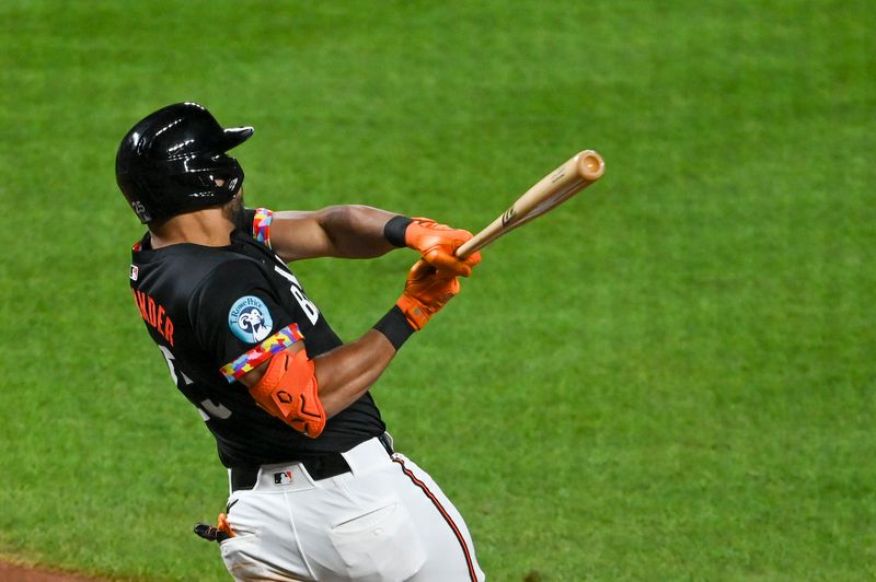 Aug 23, 2024; Baltimore, Maryland, USA; Baltimore Orioles right fielder Anthony Santander (25) swings through a eighth inning grand slam against the Houston Astros at Oriole Park at Camden Yards. Mandatory Credit: Tommy Gilligan-USA TODAY Sports