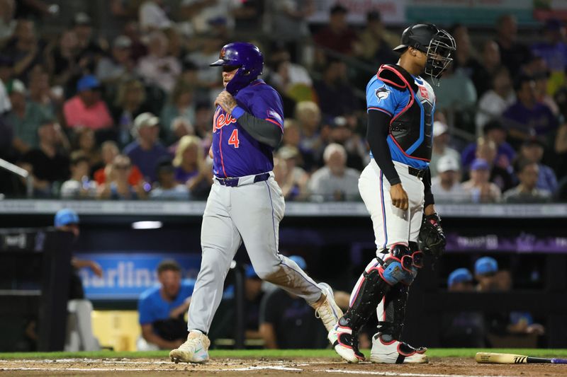 Mar 8, 2024; Jupiter, Florida, USA; New York Mets catcher Francisco Alvarez (4) scores against the Miami Marlins during the second inning at Roger Dean Chevrolet Stadium. Mandatory Credit: Sam Navarro-USA TODAY Sports