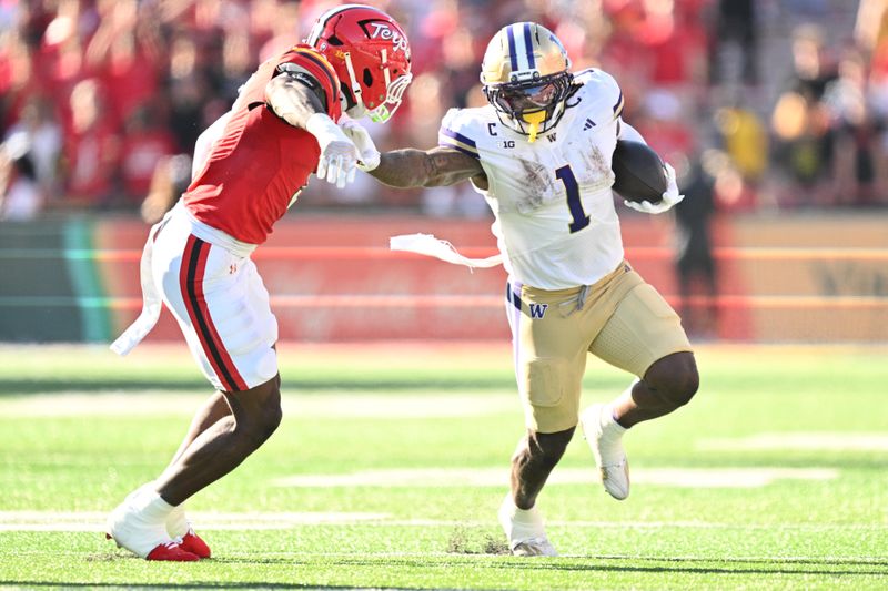 Oct 4, 2025; College Park, Maryland, USA;  Washington Huskies running back Jonah Coleman (1) stiff arms Maryland Terrapins linebacker Trey Reddick (3)  while picking up yardage in the first half at SECU Stadium. Mandatory Credit: Jamie Sabau-Imagn Images