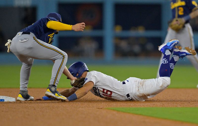 Aug 17, 2023; Los Angeles, California, USA;  Los Angeles Dodgers catcher Austin Barnes (15) beats the throw to Milwaukee Brewers shortstop Willy Adames (27) for a stolen base in the third inning at Dodger Stadium. Mandatory Credit: Jayne Kamin-Oncea-USA TODAY Sports