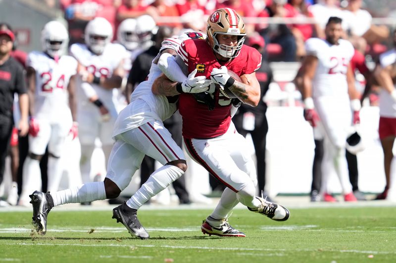 San Francisco 49ers tight end George Kittle, right, is tackled by Arizona Cardinals safety Jalen Thompson during the first half of an NFL football game in Santa Clara, Calif., Sunday, Oct. 6, 2024. (AP Photo/Godofredo A. Vásquez)