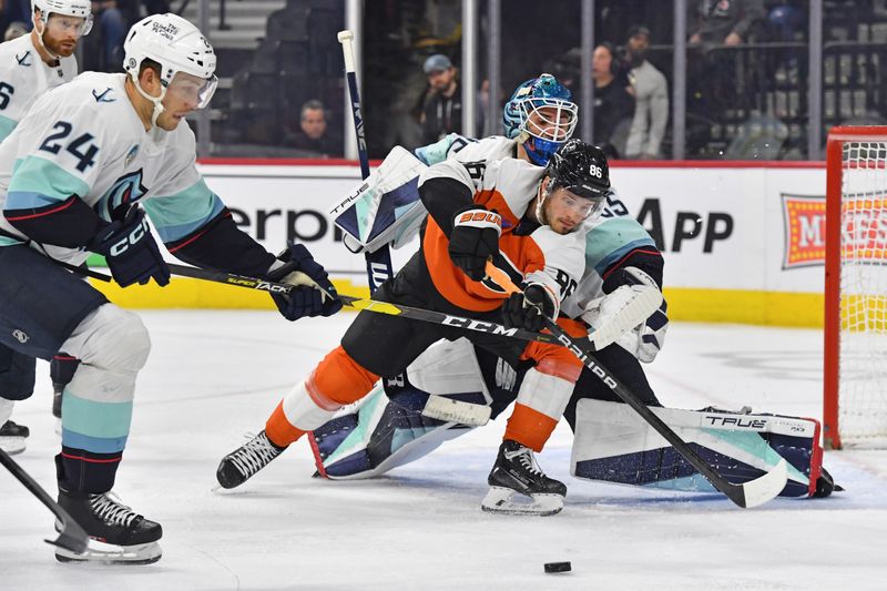 Feb 10, 2024; Philadelphia, Pennsylvania, USA; Philadelphia Flyers left wing Joel Farabee (86) and Seattle Kraken defenseman Jamie Oleksiak (24) reach for the puck in front of goaltender Joey Daccord (35) during the third period at Wells Fargo Center. Mandatory Credit: Eric Hartline-USA TODAY Sports