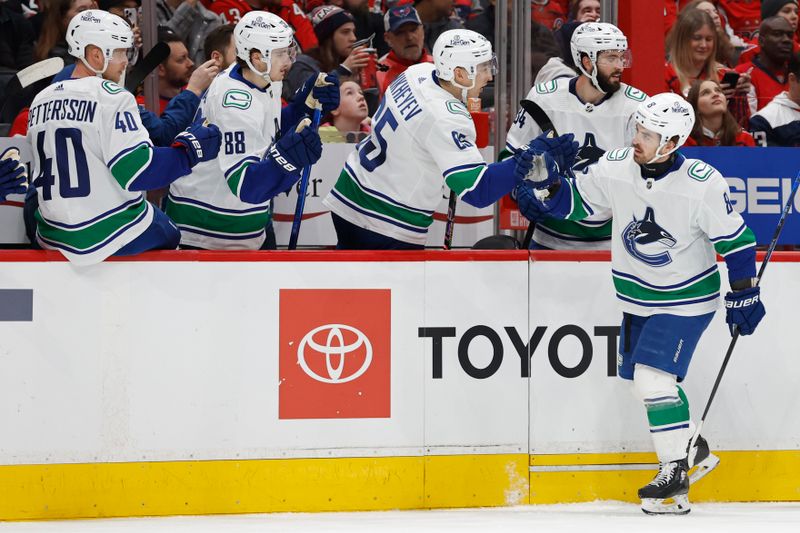 Feb 11, 2024; Washington, District of Columbia, USA; Vancouver Canucks right wing Conor Garland (8) celebrates with teammates after scoring a goal against the Washington Capitals in the first period at Capital One Arena. Mandatory Credit: Geoff Burke-USA TODAY Sports