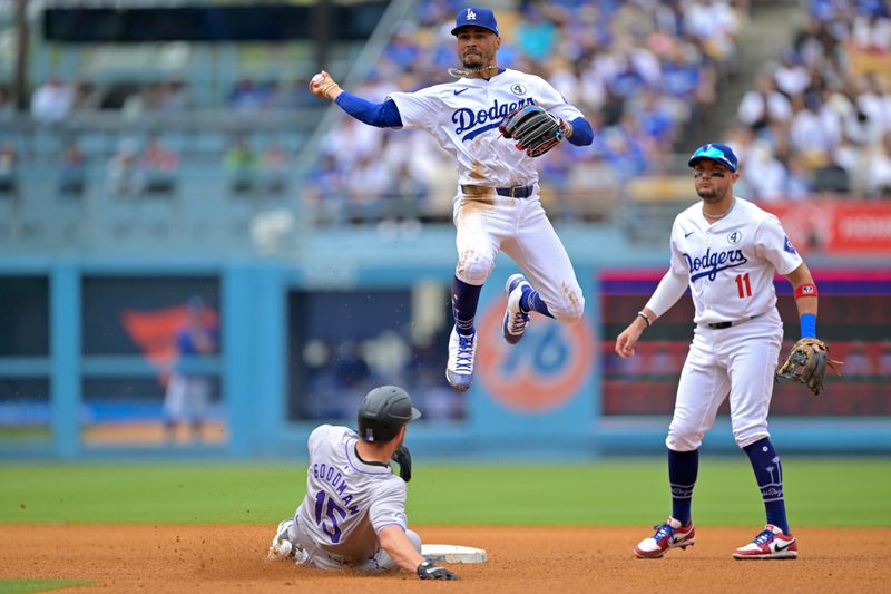 Jun 2, 2024; Los Angeles, California, USA;  Los Angeles Dodgers shortstop Mookie Betts (50) throws to first after a getting Colorado Rockies outfielder Hunter Goodman (15) out at second in the fifth inning at Dodger Stadium. Mandatory Credit: Jayne Kamin-Oncea-USA TODAY Sports