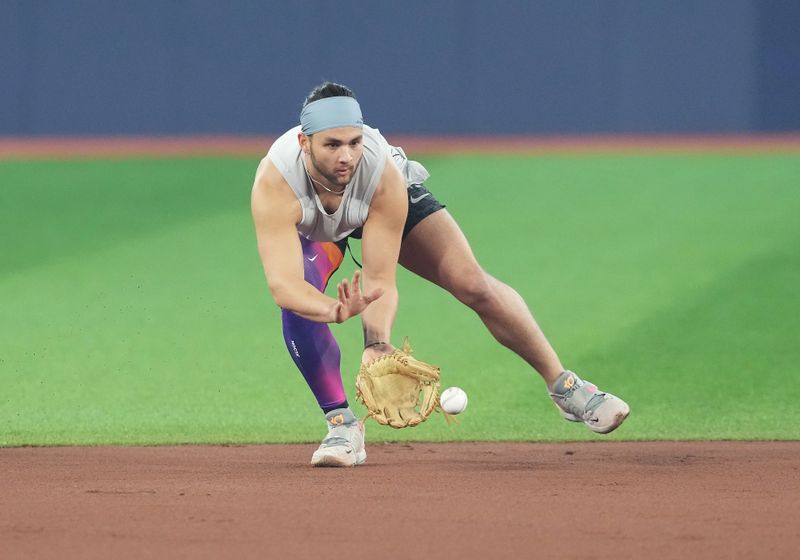 Jun 28, 2023; Toronto, Ontario, CAN; Toronto Blue Jays shortstop Bo Bichette (11) fields balls during batting practice against the San Francisco Giants at Rogers Centre. Mandatory Credit: Nick Turchiaro-USA TODAY Sports