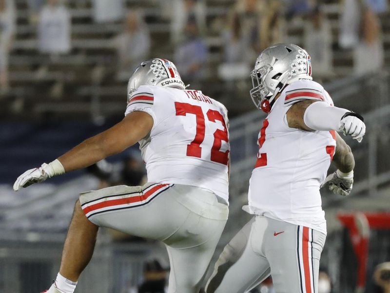 Oct 31, 2020; University Park, PA, USA; Ohio State Buckeyes defensive tackle Tommy Togiai (72) celebrates after sacking Penn State Nittany Lions quarterback Sean Clifford, not pictured, with teammate Ohio State Buckeyes defensive tackle Haskell Garrett (92) during the third quarter of a NCAA football game at Beaver Stadium in University Park, Pa. on Saturday, Oct. 31, 2020. Mandatory Credit: Adam Cairns/Columbus Dispatch-USA TODAY NETWORK