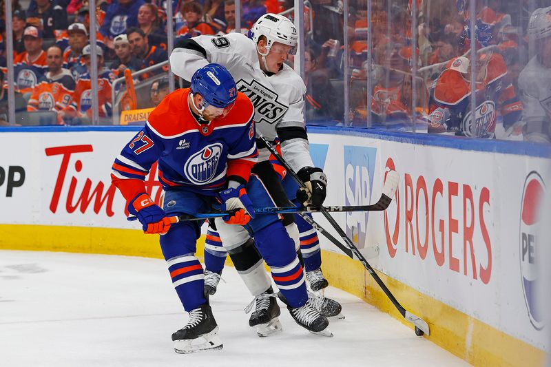 May 1, 2025; Edmonton, Alberta, CAN; Edmonton Oilers. defensemen Brett Kulak (27)  and Los Angeles Kings forward Samuel Helenius (79) battle along the boards for a loose puck  during the second period in game six of the first round of the 2025 Stanley Cup Playoffs at Rogers Place. Mandatory Credit: Perry Nelson-Imagn Images