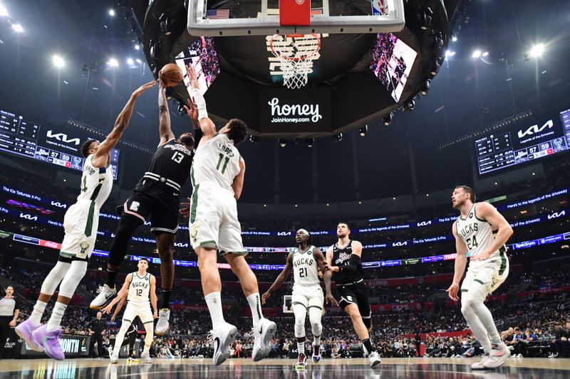 LOS ANGELES, CA - FEBRUARY 10: Paul George #13 of the LA Clippers rebounds the ball during the game against the Milwaukee Bucks on February 10, 2023 at Crypto.Com Arena in Los Angeles, California. NOTE TO USER: User expressly acknowledges and agrees that, by downloading and/or using this Photograph, user is consenting to the terms and conditions of the Getty Images License Agreement. Mandatory Copyright Notice: Copyright 2023 NBAE (Photo by Adam Pantozzi/NBAE via Getty Images)