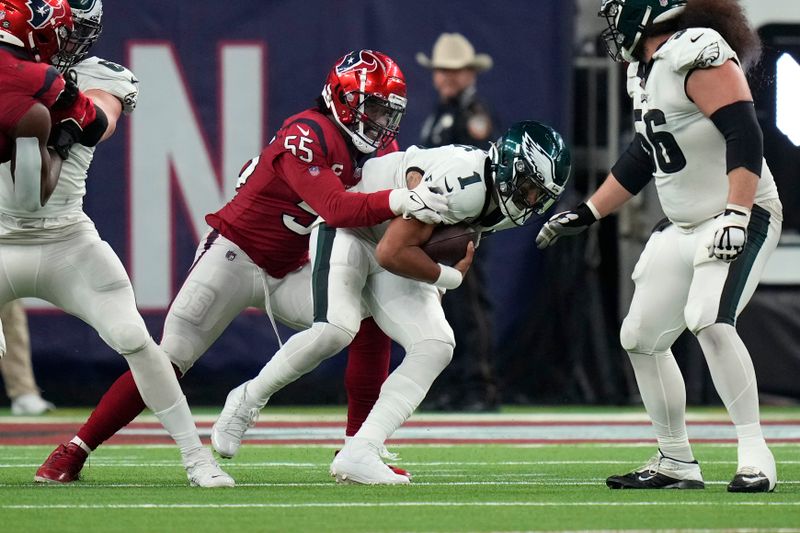 Philadelphia Eagles quarterback Jalen Hurts (1) is brought down by Houston Texans defensive end Jerry Hughes (55) in the second half of an NFL football game in Houston, Thursday, Nov. 3, 2022. (AP Photo/Eric Christian Smith)