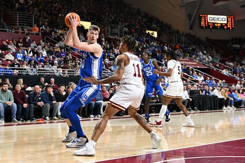 Jan 7, 2023; Chestnut Hill, Massachusetts, USA; Duke Blue Devils center Kyle Filipowski (30) controls the ball against Boston College Eagles guard Makai Ashton-Langford (11) during the first half at the Conte Forum. Mandatory Credit: Brian Fluharty-USA TODAY Sports