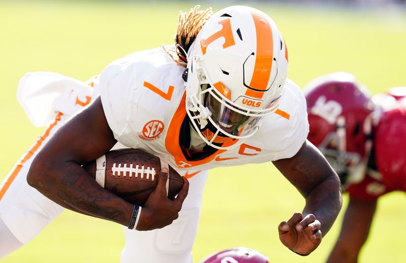 Oct 21, 2023; Tuscaloosa, Alabama, USA; Tennessee Volunteers quarterback Joe Milton III (7) scrambles against the Alabama Crimson Tide during the first half at Bryant-Denny Stadium. Mandatory Credit: John David Mercer-USA TODAY Sports